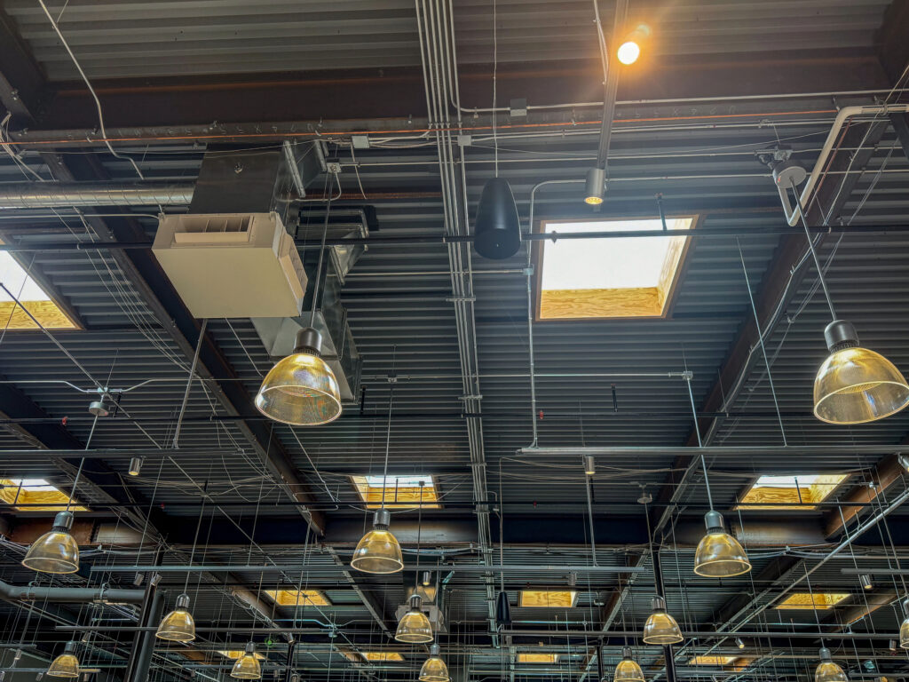 Barney Bros Electric Inc. industrial ceiling wiring, pipes, and pendant lights